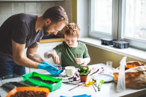 Father and son planting at home